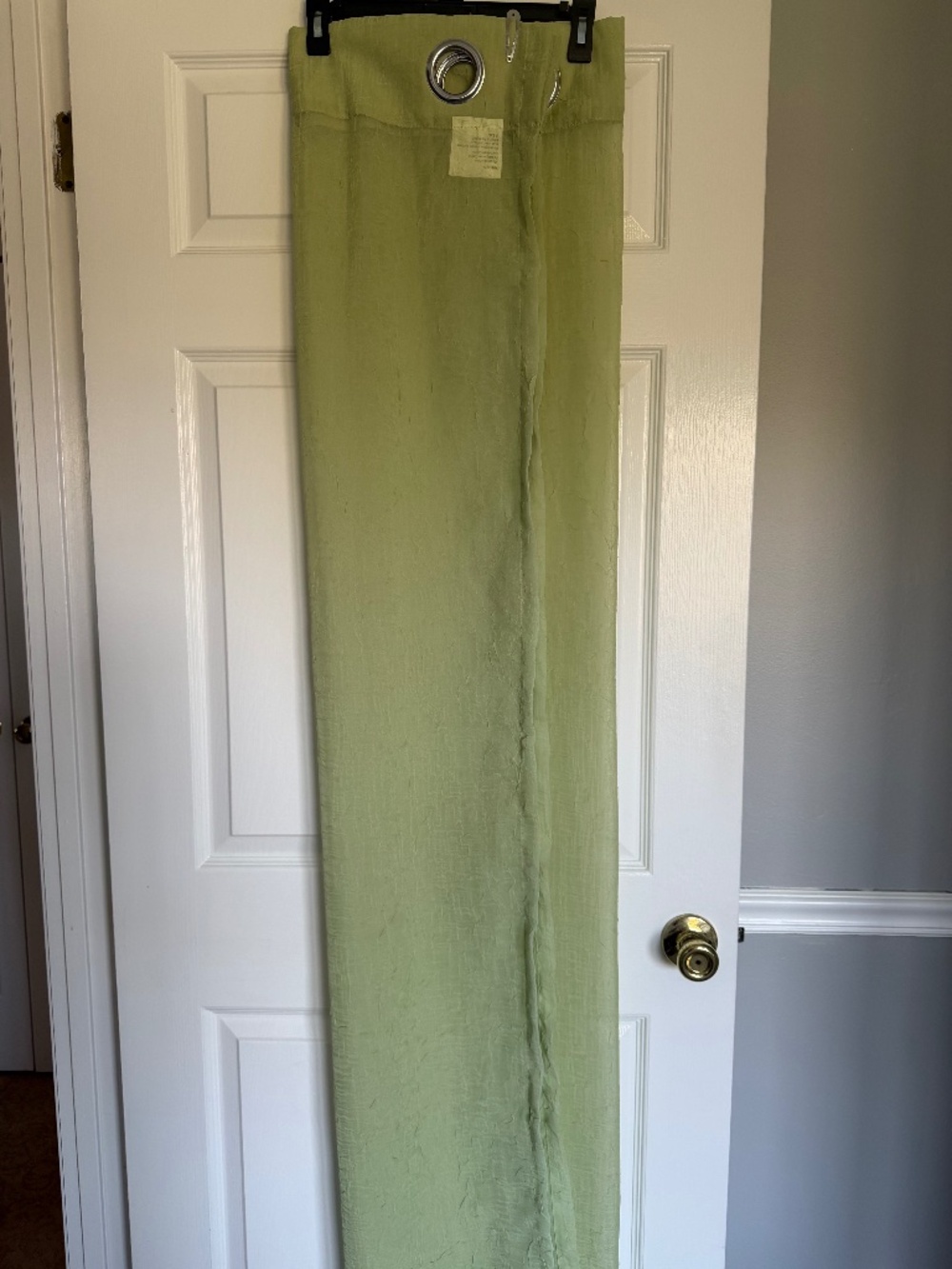 Pair of Grommett Top Green Sheer Curtains